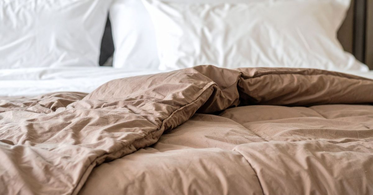 Beige comforter on bed