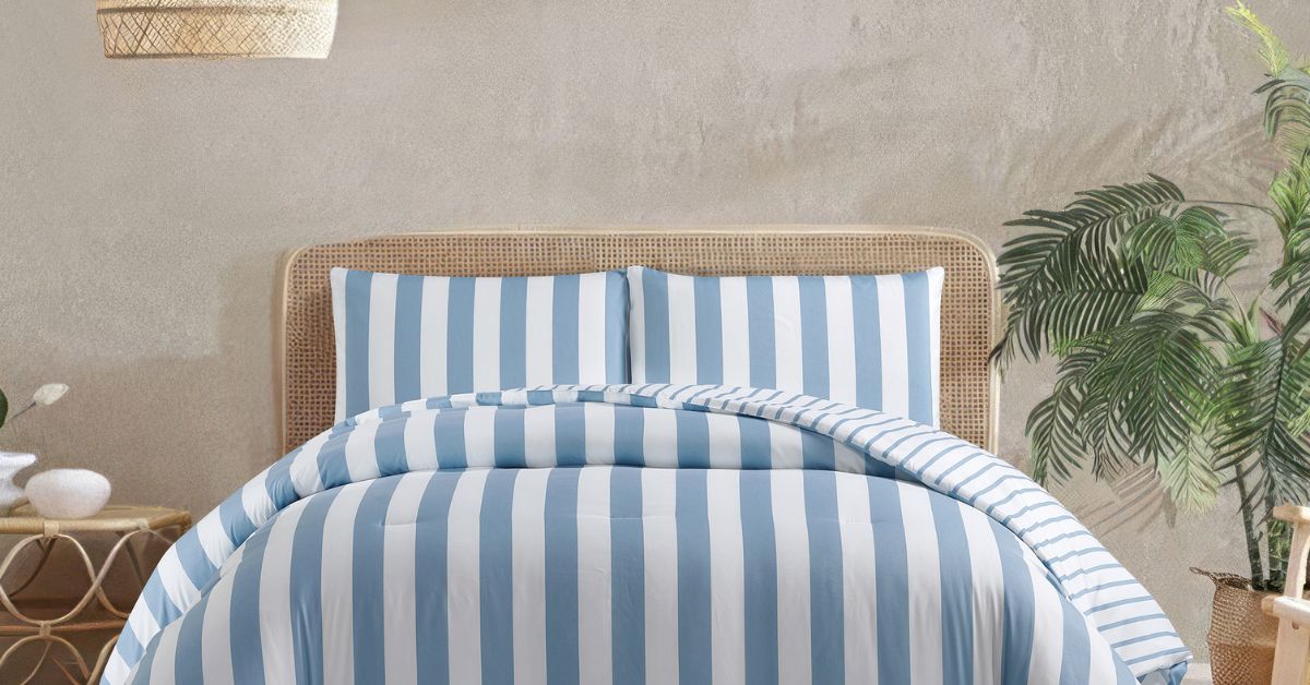 Blue and white striped comforter on a bed with a woven whicker frame