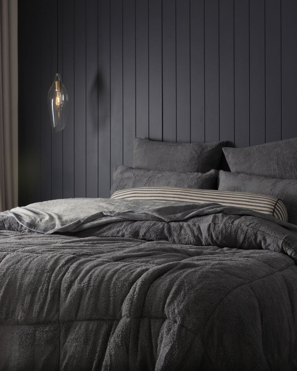 Morgan and Reid Charcoal Snuggle Fleece Pillowcase Pair on bed with coordinating bedding